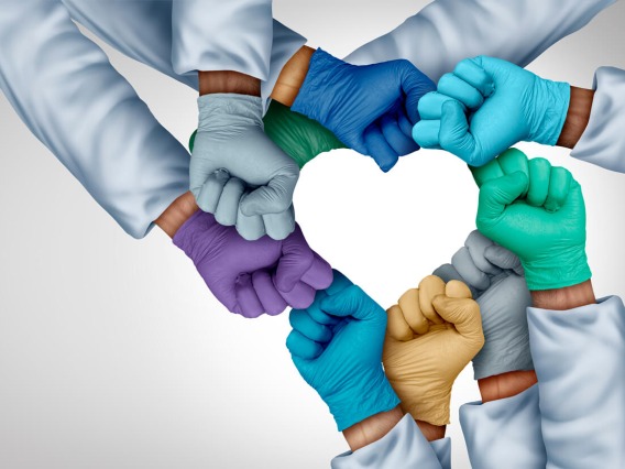 multi-colored gloved hands forming shape of a heart