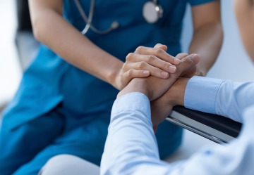 doctor holding patient's hands